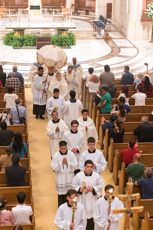 Archbishop Thomas Wenski carries the Blessed Sacrament through the church to its place in the Cathedral chapel for adoration at the conclusion of the Holy Thursday Mass of the Last Supper at St. Mary Cathedral, April 17, 2025.