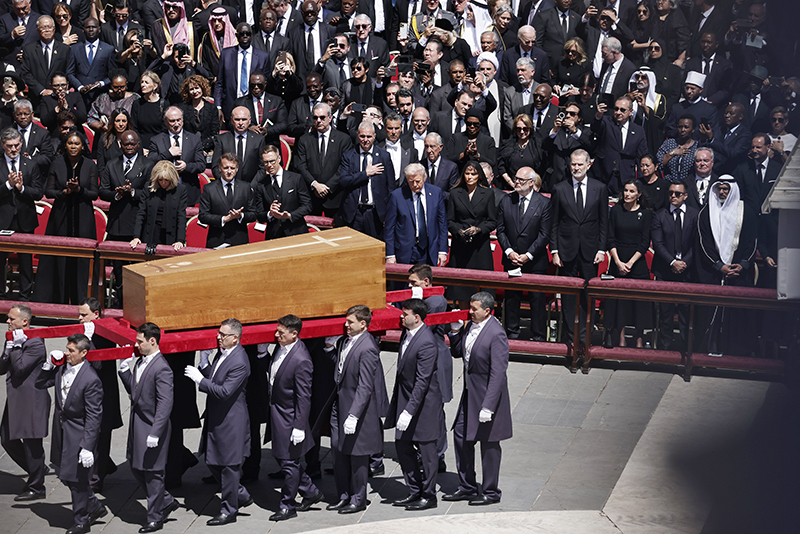 Fourteen pallbearers carry the casket of Pope Francis past world leaders, including U.S. President Donald J. Trump, center, at the end of the pope's funeral Mass April 26, 2025, in St. Peter's Square at the Vatican.