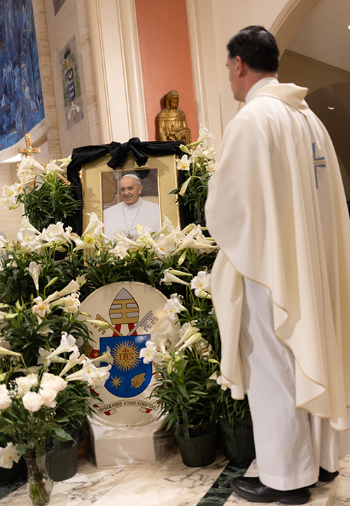 Father Rafael Capó, vice president of Mission for St. Thomas University, prays in front of a picture of Pope Francis following the Mass celebrated by Archbishop Thomas Wenski for the repose of the Pope's soul April 26, 2025, the same day of his funeral in Rome.