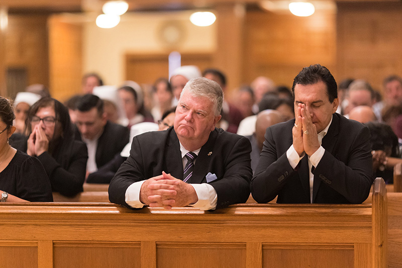 From left, Ricardo Grzona, executive president of the Ramón Pané Foundation, and Manuel Pelaez, a lay minister at St. John XXIII Church in Miramar, pray during Mass for the repose of the soul of Pope Francis April 26, 2025. The Mass was celebrated by Archbishop Thomas Wenski at St. Mary Cathedral in Miami on the same day as the Pope’s funeral in Rome.