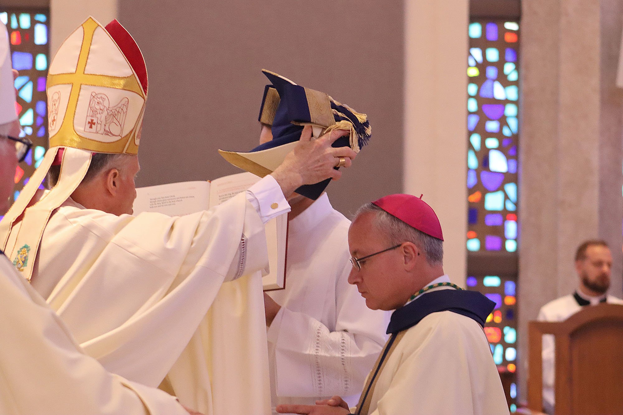 Archbishop Timothy P. Broglio of the U.S. Archdiocese for the Military Services places a mitre on top of the head of Bishop-designate Gregg M. Caggianelli as part of his episcopal ordination as an auxiliary bishop for the military archdiocese at St. Vincent de Paul Regional Seminary in Boynton Beach, Fla., May 9, 2025.