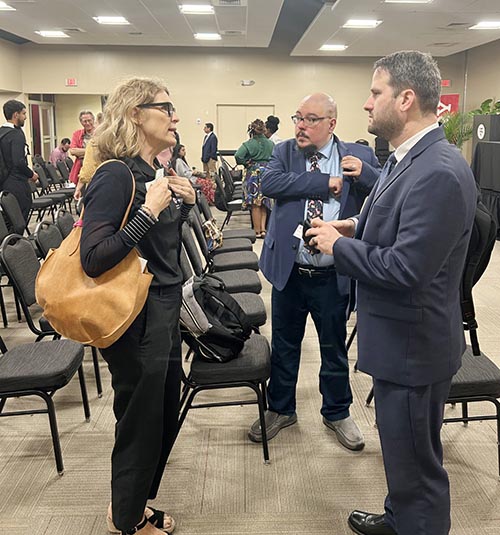 Kim Santomauro, a volunteer with the American Red Cross, networks with Joseph Kano of Catholic Legal Services of Miami at the Barry University Institute for Immigration Studies 2nd Annual Conference held on April 9-10, 2025 in Miami Shores.