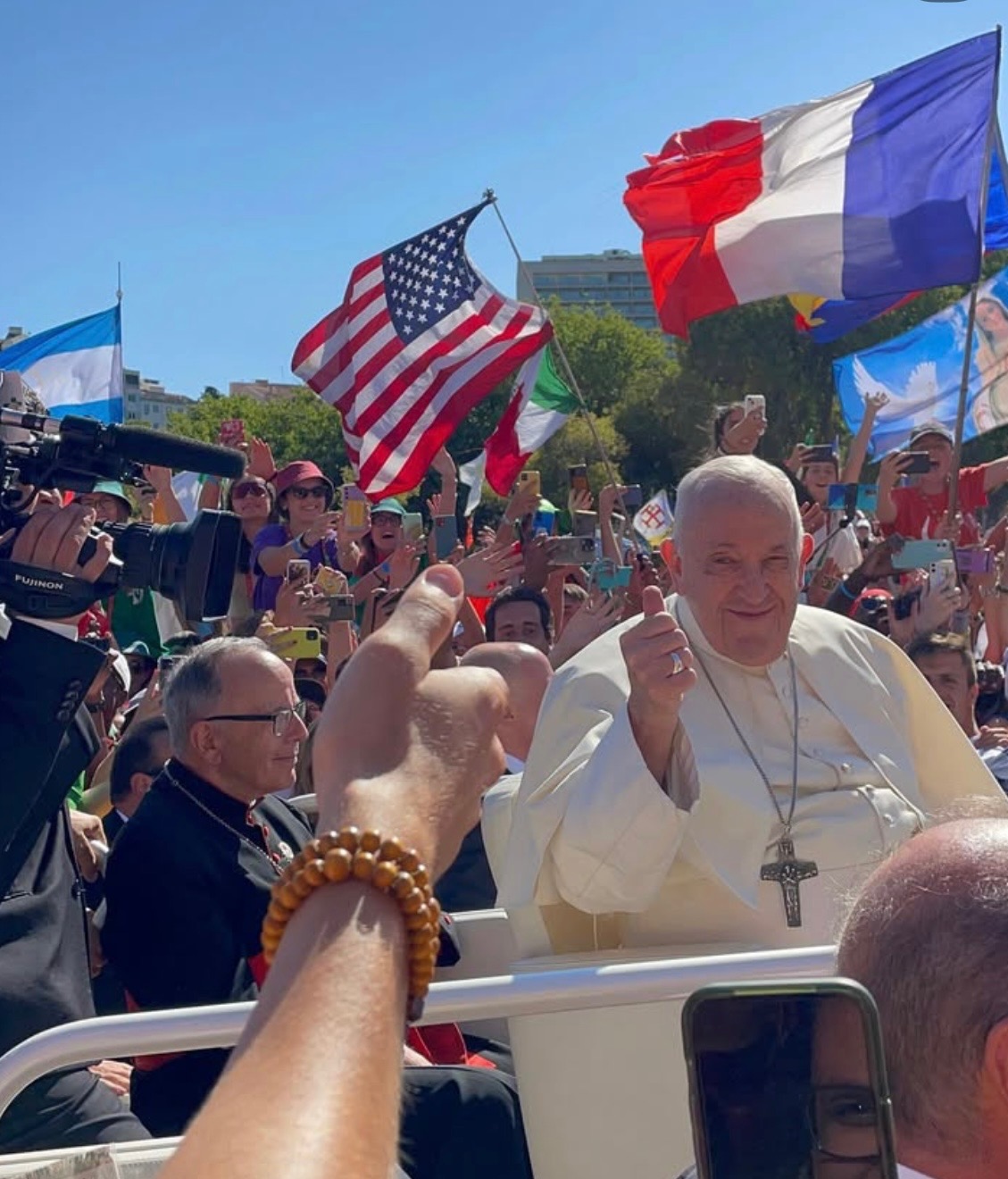 Pope Francis drives in front of St. Thomas University students attending World Youth Day in Lisbon, Portugal Aug. 2023.