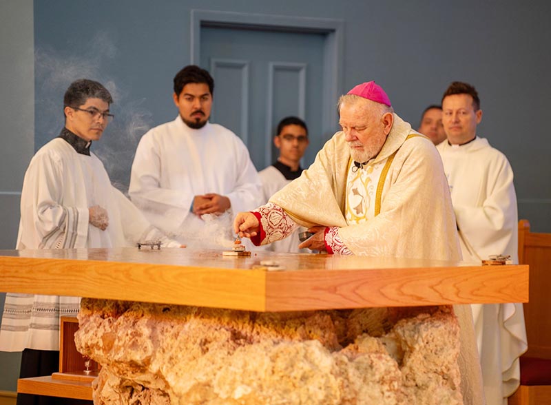 Archbishop Thomas Wenski consecrates the new altar during the rededication Mass of the Chapel of St. Anthony at St. Thomas University in Miami Gardens on April 29, 2025.