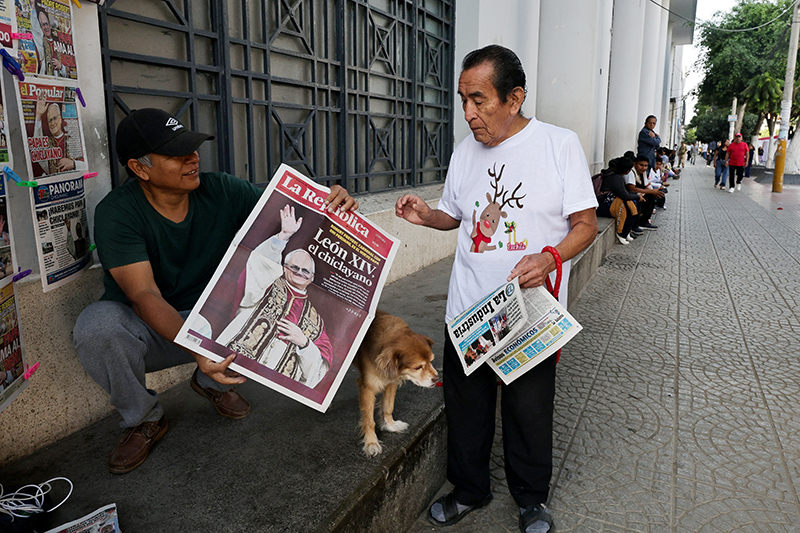 People hold newspapers in Chiclayo, Peru, May 9, 2025, reporting on the election of Pope Leo XIV, who is a dual U.S.-Peruvian citizen. Formerly Cardinal Robert F. Prevost, the prelate was elected pope May 8 at the Vatican, becoming the first American pope in history. As an Augustinian priest, then-Father Prevost spent many years as a missionary in Peru.