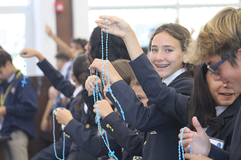 Sixth graders from Catholic schools in the Archdiocese of Miami hold up rosaries they received at the Focus 11 Vocations Rally to be blessed on May 15, 2025, at St. John Vianney College Seminary.