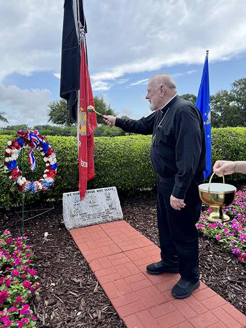 Archbishop Thomas Wenski blesses the military veterans section of Our Lady Queen of Heaven Cemetery in North Lauderdale after laying a wreath in honor of those who died while serving in the nation's military, May 26, 2025.