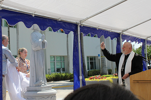 Archbishop Thomas Wenski sprinkles holy water on the new St. Catherine Labouré statue at St. Catherine's West Rehabilitation Hospital in Hialeah Gardens on May 15, 2025.