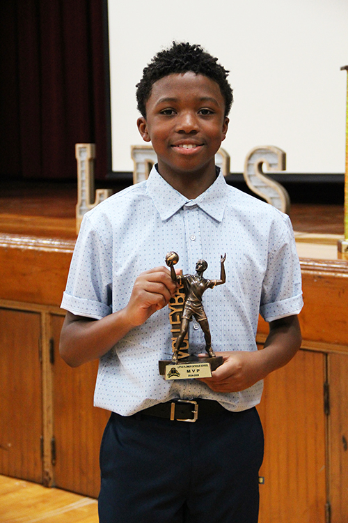 Jayden Roberts is awarded boys volleyball MVP at Little Flower School’s 2024-25 Sports Awards Banquet May 22, 2025, celebrating the achievements of the school’s athletes.