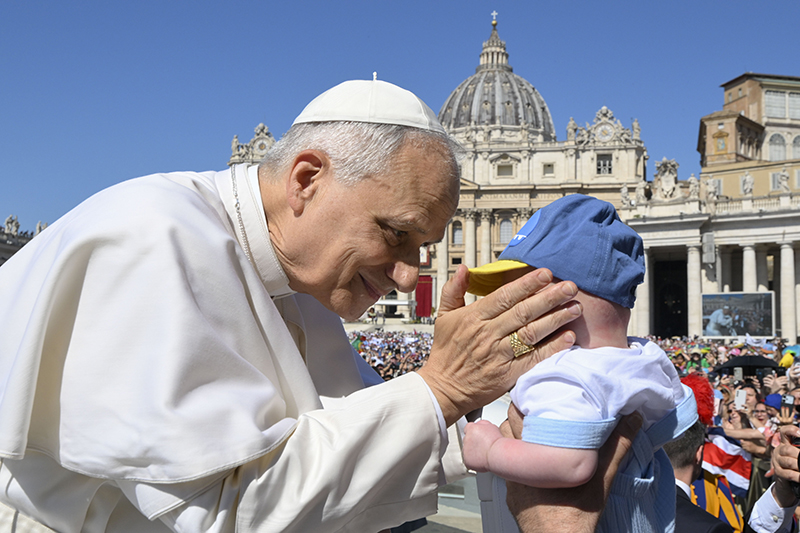 Pope Leo XIV greets a child as he rides in the popemobile before celebrating Mass in St. Peter’s Square at the Vatican June 1, 2025, as part of the Jubilee of Families, Children, Grandparents and the Elderly.