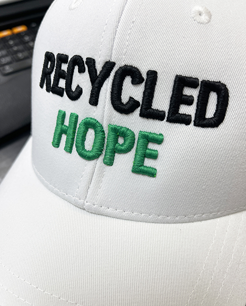 Christopher Columbus High School’s Environmental Club created these Recycled Hope baseball caps, made from recycled water bottles, for Castaways Against Cancer during Fall 2024. Castaways Against Cancer then provided these caps to the University of Miami Sylvester Comprehensive Cancer Center, for the use of cancer patients.