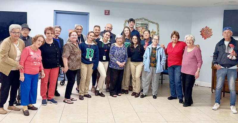 CyberWise Seniors and volunteers from St. Brendan High School host a Christmas celebration at the Palmer House in Miami, playing “Emoji Bingo” with seniors Dec. 2, 2024. CyberWise Seniors strives to equip the elderly to independently and safely navigate technology.