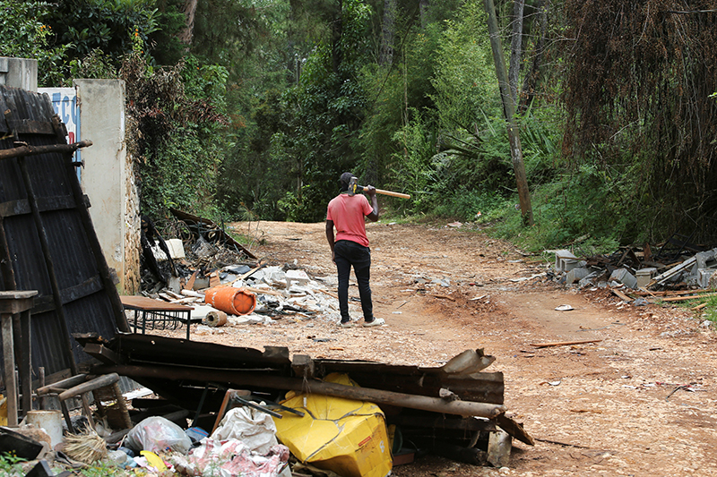 A neighborhood watch member in Furcy, Haiti, holds a hammer to clear roads blocked by gangs and break down walls for police access June 24, 2025, after gangs torched homes at a residential neighborhood amid a surge in violence that has displaced approximately 1.3 million people in six months, according to U.N. estimates.