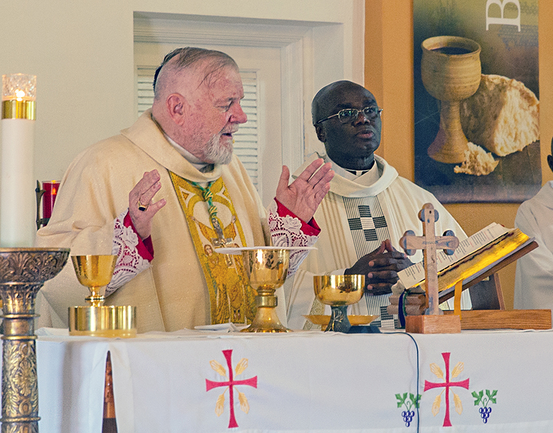 Archbishop Thomas Wenski celebrates Mass with Spiritan Father Fidelis Nwankwo. During the Mass Archbishop Wenski installed Father Nwankwo as pastor of St. Philip Neri Church in Miami Gardens, June 22, 2025.