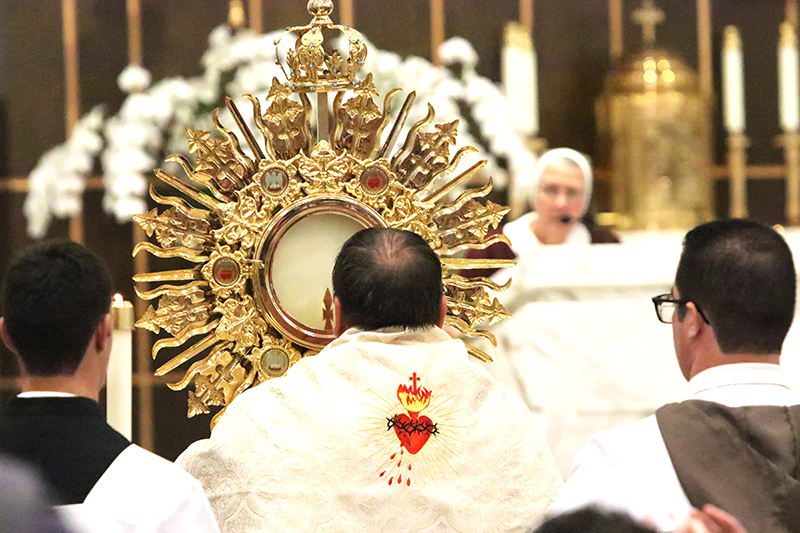 Deacon Ismar Martinez processes with the Blessed Sacrament during the Great Vigil in Honor of the Two Hearts of Jesus and Mary June 27, 2025, at Our Lady of Guadalupe Parish in Doral.