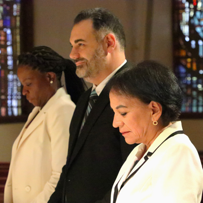 Newly named school principals bow their heads during a blessing at a Mass celebrated on July 2, 2025 at St. Martha Parish in Miami Shores. From left is Faradjah Muller, principal of Holy Family School in North Miami; David Revezzo, principal of Mary Help of Christians School, Parkland; Renee Sarmiento, principal of St. Andrew School in Coral Springs; and Deonte Green (not pictured), principal of Cristo Rey Miami High School, Miami.