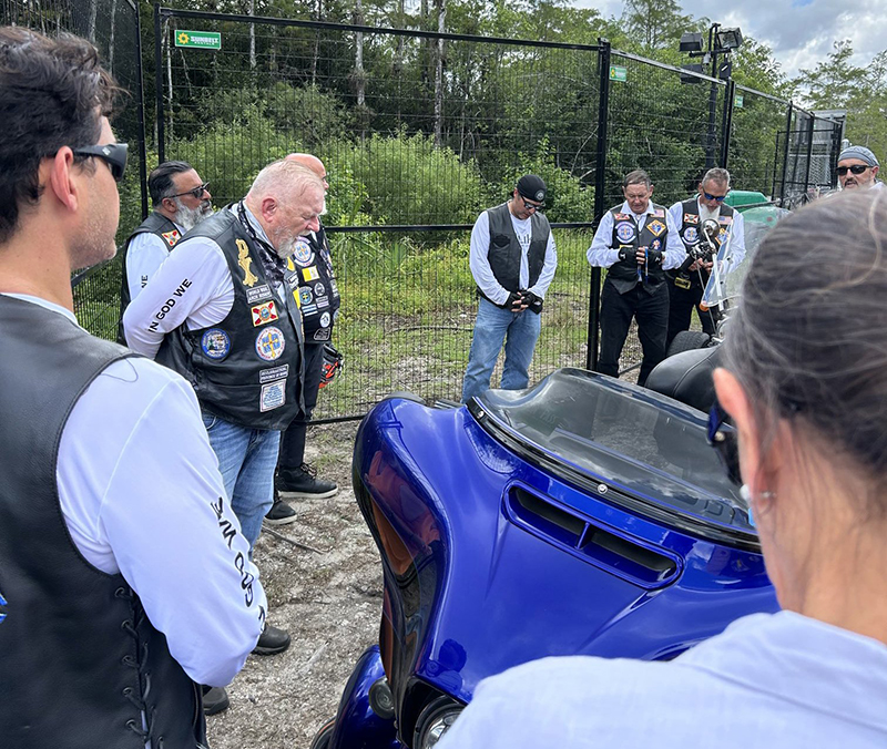 Archbishop Thomas G. Wenski (second from left) and the Knights on Bikes of the Knights of Columbus pray the rosary for detainees at the entrance of Alligator Alcatraz, an immigration detention center in the Florida Everglades July 20, 2025.