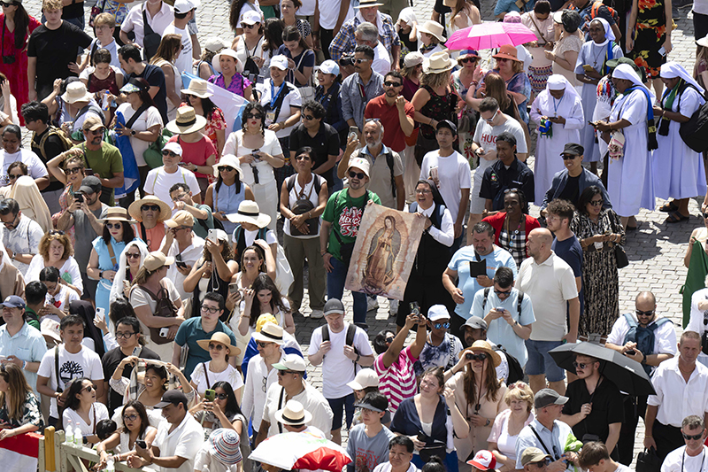 Visitors hold an image of Our Lady of Guadalupe as they gather in St. Peter’s Square at the Vatican for the Angelus with Pope Leo XIV July 27, 2025.