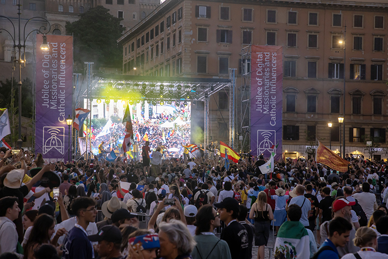 Young people attend a concert in Risorgimento Square in Rome July 29, 2025, during the Jubilee of Digital Missionaries and Catholic Influencers. The event featured live music, dancing and international flags, with a large screen broadcasting images from earlier moments in the celebration.