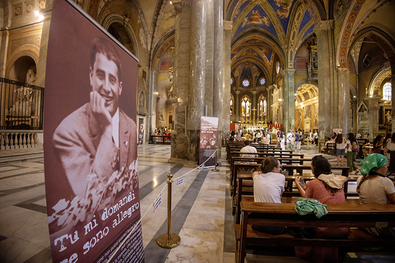 Pilgrims visit the Basilica of Santa Maria sopra Minerva in Rome July 31, 2025, where the relics of Blessed Pier Giorgio Frassati have been brought for the Jubilee of Youth. Banners inside the basilica feature images and quotes from the blessed, whose casket containing his remains were brought from his tomb in Turin for veneration.