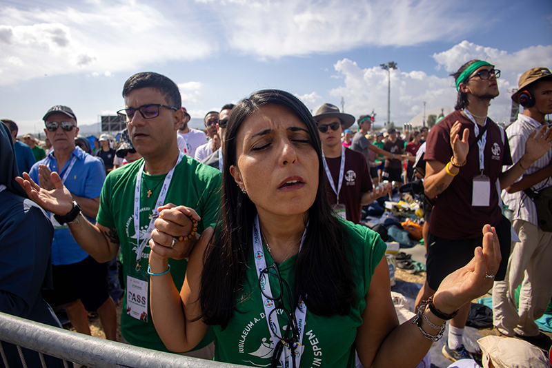 People pray during a Mass closing the Jubilee of Youth in Rome’s Tor Vergata neighborhood Aug. 3, 2025.