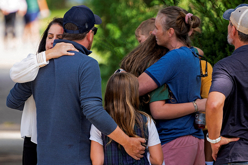 Families and loved reunite following a shooting at Annunciation Catholic School in Minneapolis Aug. 27, 2025. A shooter opened fire with a rifle through the windows of a the school's church and struck children celebrating Mass during the first week of school, killing two and wounding 17 people in an act of violence the police chief called “absolutely incomprehensible.”