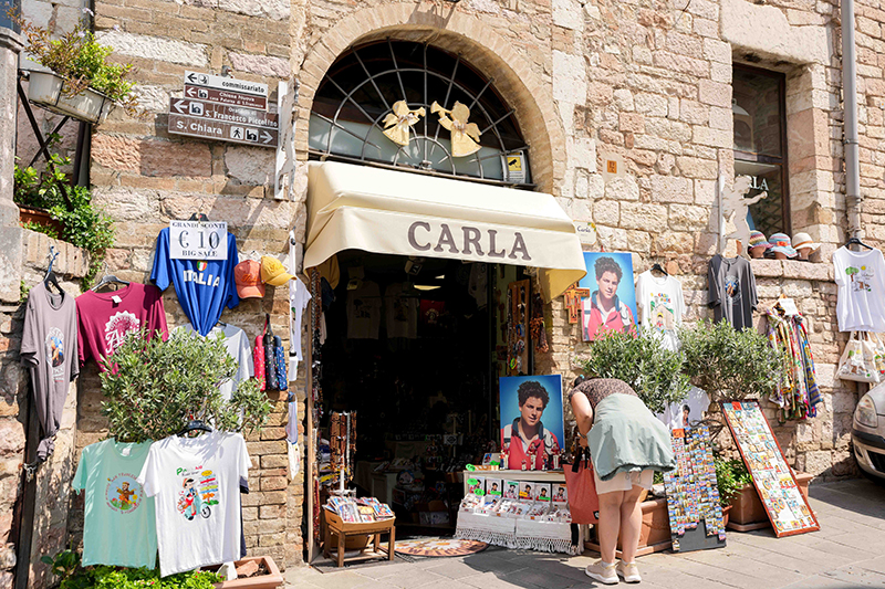 A shop in Assisi, Italy, displays souvenirs featuring Blessed Carlo Acutis Aug. 21, 2025. Acutis, who died in 2006 at age 15, will be canonized Sept. 7 at the Vatican by Pope Leo XIV.