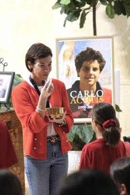 St. Louis Covenant School sixth grade teacher Denise Santurio distributes Communion during a Mass in honor of St. Carlo Acutis on Sept. 5, 2025. Following the liturgy, a "Canonization Celebration" took place at St. Louis Covenant School in Pinecrest.