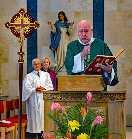 Deacon Philip Newton proclaims the Gospel during a Mass in which Archbishop Thomas Wenski installed Msgr. Dariusz Zielonka, archdiocesan chancellor for canonical affairs, as pastor of St. Pius X Church in Fort Lauderdale Sept. 7, 2025.