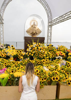 Pilgrims braved heavy rain downpours to place flowers and pray Sept. 8, 2025 at the The National Shrine of Our Lady of Charity in Miami, affectionately known as La Ermita de La Caridad, for the annual feast of Our Lady of Charity and the  25th anniversary of La Ermita’s designation as a National Shrine by the United States Conference of Catholic Bishops in 2000.