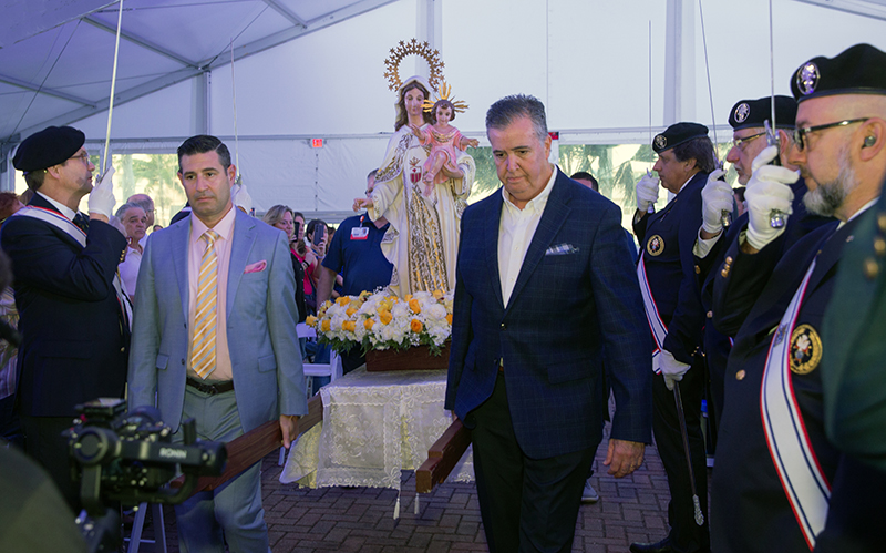 Mercy Hospital employees process into the Mass carrying the image of Our Lady of Mercy as the Knights of Columbus provide an honor guard. Archbishop Thomas Wenski celebrated a Mass for the hospital's 75th anniversary, Sept. 24, 2025.