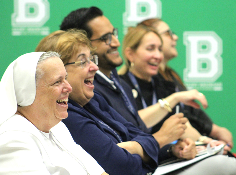 Catholic school principals and faculty laugh during a session led by Donald Edwards, associate superintendent of Catholic schools for the Archdiocese of Miami, at the Bridging the Gap Conference at St. Brendan High School in Miami, Sept. 26, 2025.