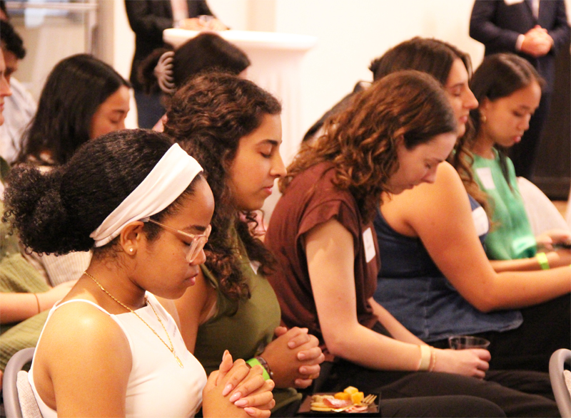 Attendees pray together at Theology on Tap: Empowering Young Catholic Professionals, which took place at the University of Miami (UM) Catholic Student Center in Coral Gables September 26, 2025.