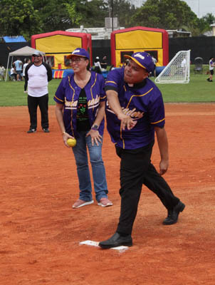 St. Michael the Archangel Parish, Miami, Pastor Father Elvis Gonzalez throws the "first pitch" at a softball game played at the inauguration and blessing of St. Michael's new athletic field on Sept. 28, 2025. Watching next to him is St. Michael the Archangel School Principal Lisette Reina-Naranjo.