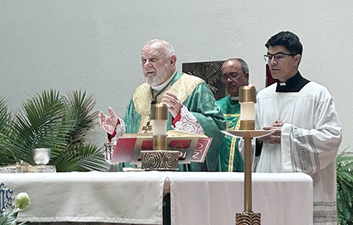 Archbishop Thomas Wenski celebrates Mass at Our Lady of the Holy Rosary-St. Richard Church in Palmetto Bay to mark the grand opening of Holy Rosary St. Richard Preschool on the parish campus. Behind him is pastor Father Yosbany Alfonso and, right, priest secretary Father Augustin Estrada.