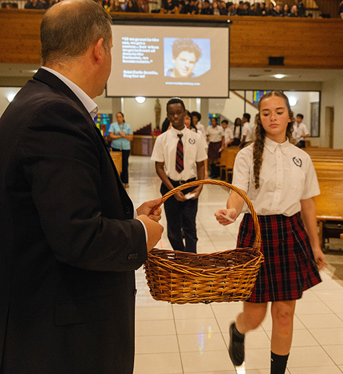 A student from St. Andrew School in Coral Springs drops a prayer request into a basket held by Dario Mobini, director of the website WorldYouthDay.com, during a presentation for Archdiocese of Miami middle school students at St. David Church in Davie, Oct. 10, 2025, about the life of St. Carlo Acutis.
Archdiocese of Miami middle school students participated at St. David Church, in a Holy Hour in the presence of a first class relic of St. Carlo Acutis, the first millenial saiint