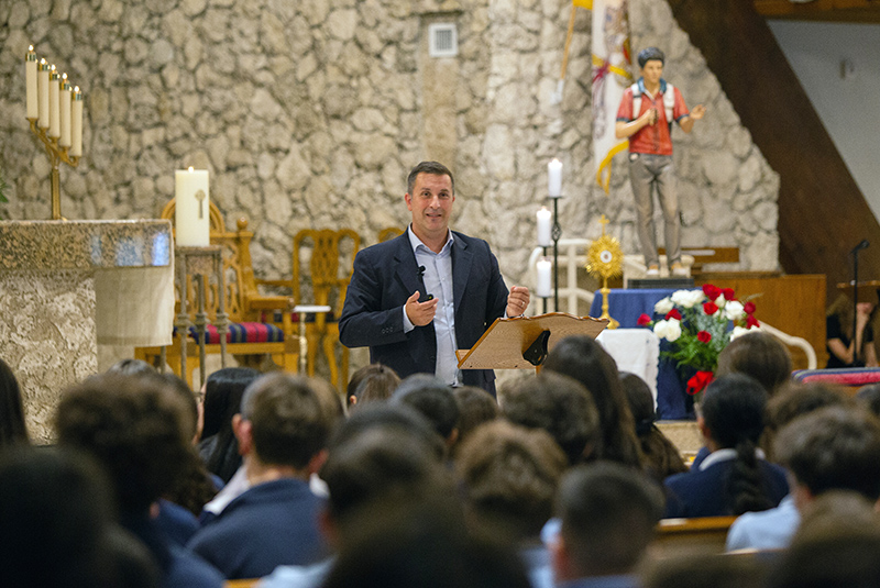 Dario Mobini, director of the website WorldYouthDay.com, addresses Archdiocese of Miami middle school students about St. Carlo Acutis, the first millennial saint, during a presentation at St. David Church in Davie Oct. 10, 2025.