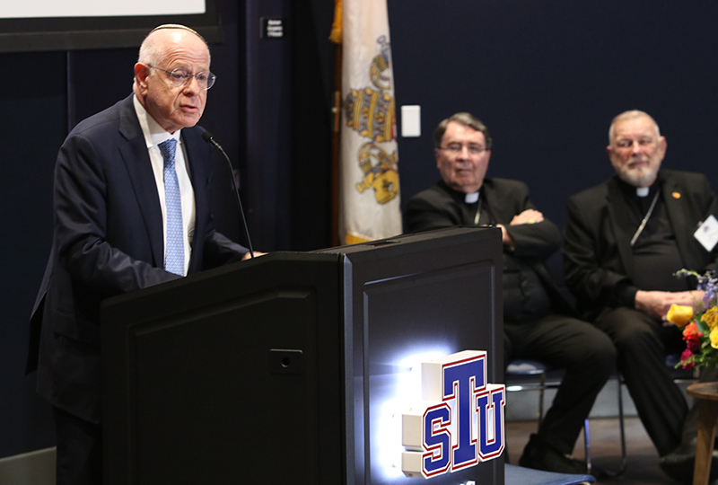 Rabbi Mario Rojzman, senior rabbi of Beth Torah Benny Rok Campus in Miami, speaks at the 60th anniversary of Nostra Aetate Oct. 20, 2025, at St. Thomas University in Miami Gardens. Listening are Cardinal Christophe Pierre, center, apostolic nuncio to the U.S., and Archbishop Thomas Wenski.