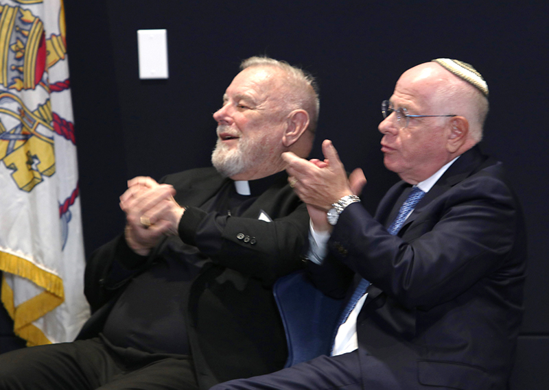 Archbishop Thomas Wenski and Rabbi Mario Rojzman applaud during the commemoration of the 60th anniversary of Nostra Aetate at St. Thomas University in Miami Gardens, Oct. 20, 2025.