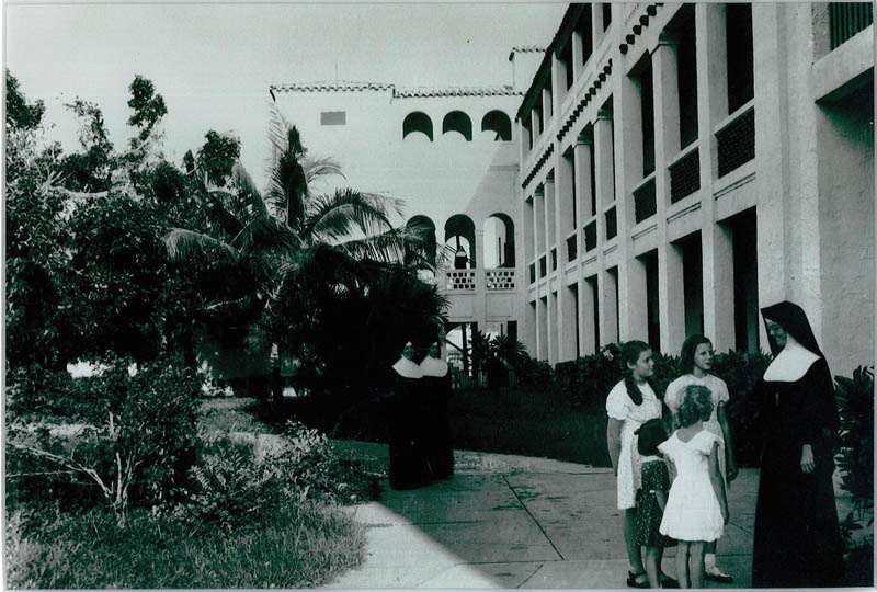 A photo taken in the 1930s reveals students of St. Joseph Academy outside in their schoolyard in conversation with a Sister of St. Joseph of St. Augustine. Nearby, other sisters of the order can be seen, as they were educators at the school. Today, the school is known as St. Theresa School, and is celebrating their centennial.