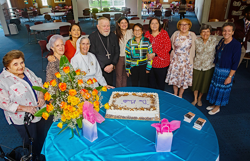Marian Center staff, lay aggregates and supporters pose for a photo with Archbishop Thomas Wenski after a Mass celebrating the 62nd anniversary of the Marian Center in Miami Oct. 21, 2025.