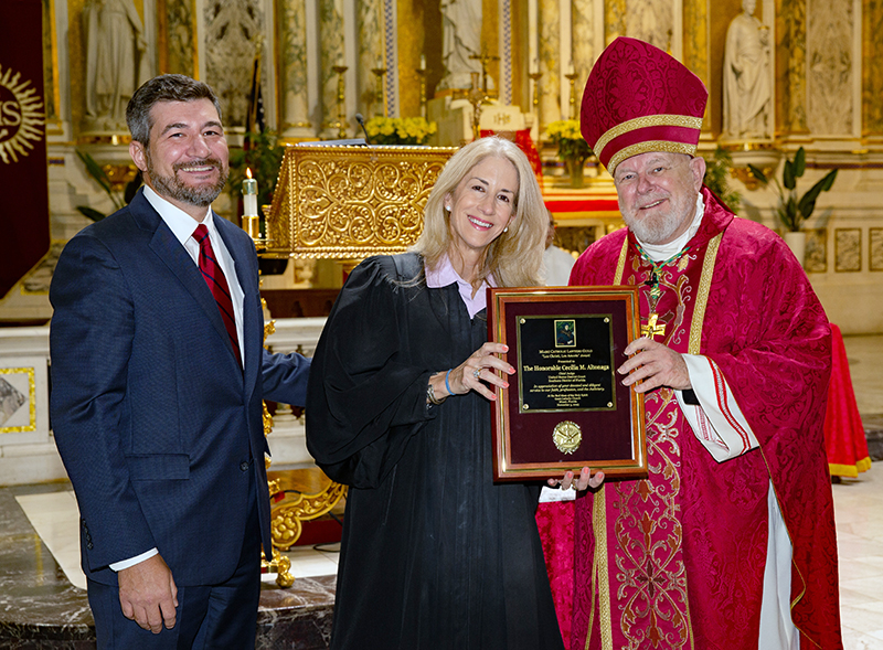 Archbishop Thomas Wenski poses with U.S. District Court Judge Rodolfo Ruiz II, who presented the 2025 Lex Christi, Lex Amoris Award from the Miami Catholic Lawyers Guild to U.S. District Chief Judge Cecilia Altonaga at the Red Mass of the Holy Spirit at Gesu Church in Miami Nov. 5, 2025.