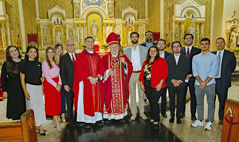 Archbishop Thomas Wenski and Father Rafael Capo, St. Thomas University (STU) vice president of Mission and Ministry, pose for a photo with STU law school students and staff after celebrating the Red Mass at Gesu Church in Miami on Nov. 5, 2025.