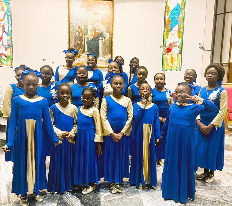 Youngsters from Holy Family Parish’s liturgical group gather at the altar shortly after the parish’s 75th anniversary Mass Nov. 15, 2025. The young girls performed throughout the evening and added to the joy of the celebration.