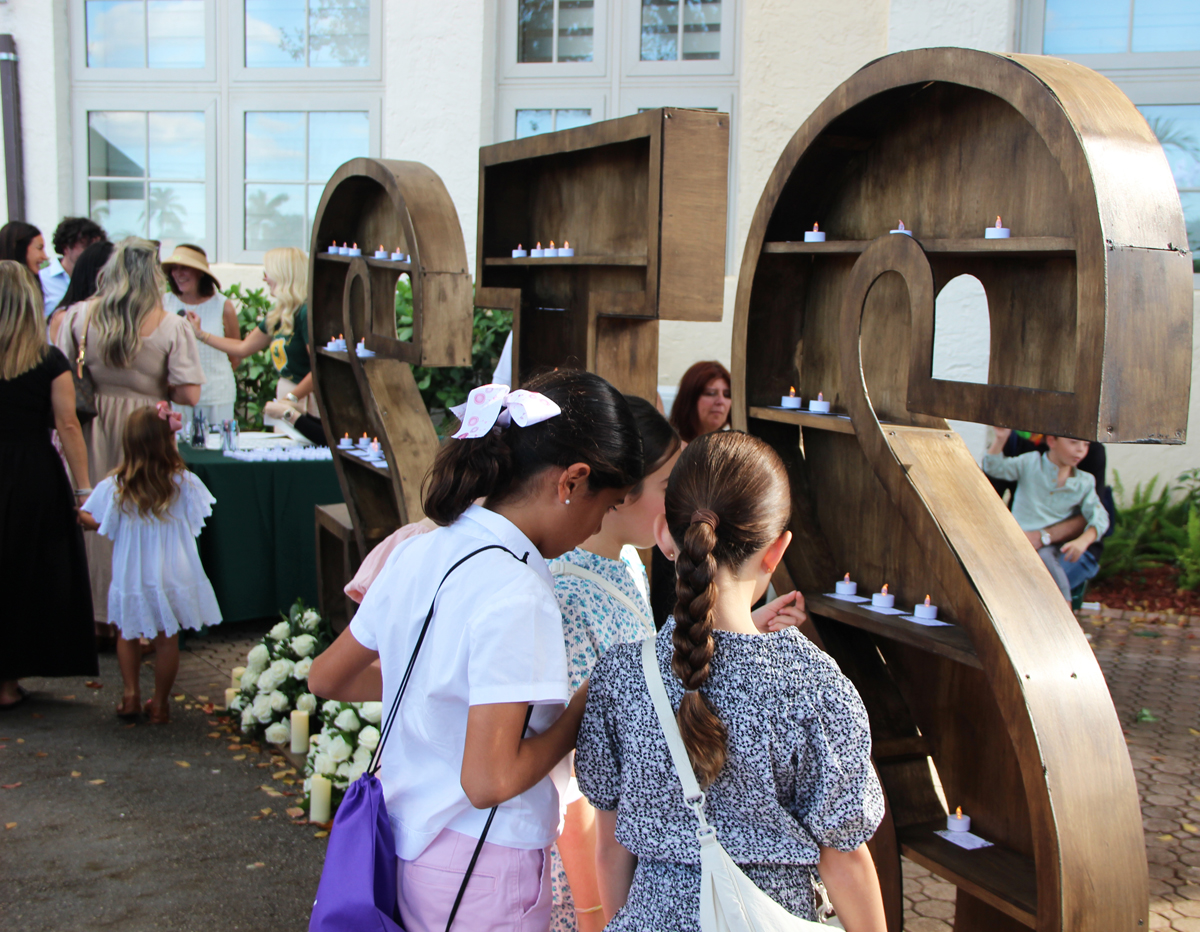 St. Theresa Catholic School students wrote prayers for future scholars on small slips of paper placed on STS-shaped shelves during the school’s 100th anniversary Mass and celebration Nov. 16, 2025, in Coral Gables. Later, the prayer intentions were included in the centennial time capsule.