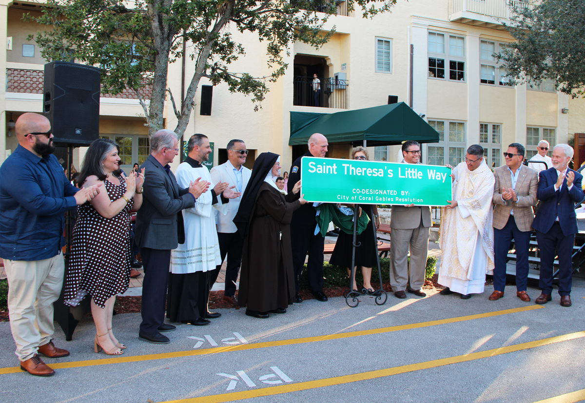 Ariel Fernandez (fourth from right), a City of Coral Gables commissioner, announced that the City of Coral Gables Commission is renaming Indian Mound Trail as “Saint Theresa’s Little Way, the street where the school is located. The announcement was part of the school’s 100th anniversary celebration Nov. 16, 2025, in Coral Gables.
