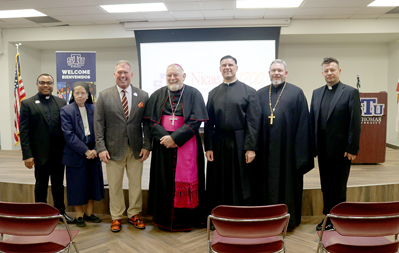 Archbishop Thomas Wenski poses for a photo with organizers and attendees of the Nicaea 1700 talk Nov. 17, 2025, at St. Thomas University (STU) in Miami Gardens. From left are Father Hilary Nwainya, theology professor at STU; Sister Elizabeth Worley, chancellor for administration and chief operating officer of the Archdiocese of Miami; David Armstrong, president of STU; Archbishop Thomas Wenski; Father Rafael Capo, vice president of mission and ministry at STU; Father Joseph Lucas, rector of Christ the Savior Orthodox Cathedral in Miami Lakes; and Father Grzegorz Rozborski, professor of theology at STU.