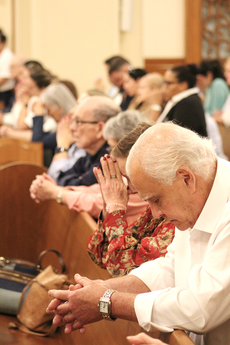 The faithful bow their heads in prayer during a Mass celebrated at the Church of the Little Flower in Coral Gables Dec. 2, 2025, in honor of the visit of the relics of St. Therese of Lisieux, "The Little Flower."