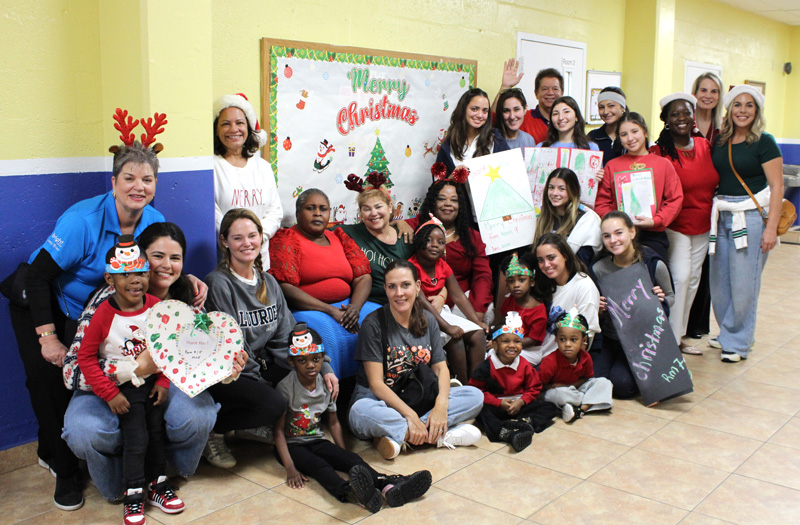 Children and staff from Catholic Charities Notre Dame Child Development Center pose with students from Lourdes Academy and staff from Las Madrinas Insurance during a holiday event on Dec. 16, 2025. On that day, over 200 children at Notre Dame received gifts donated by the Lourdes Academy community.