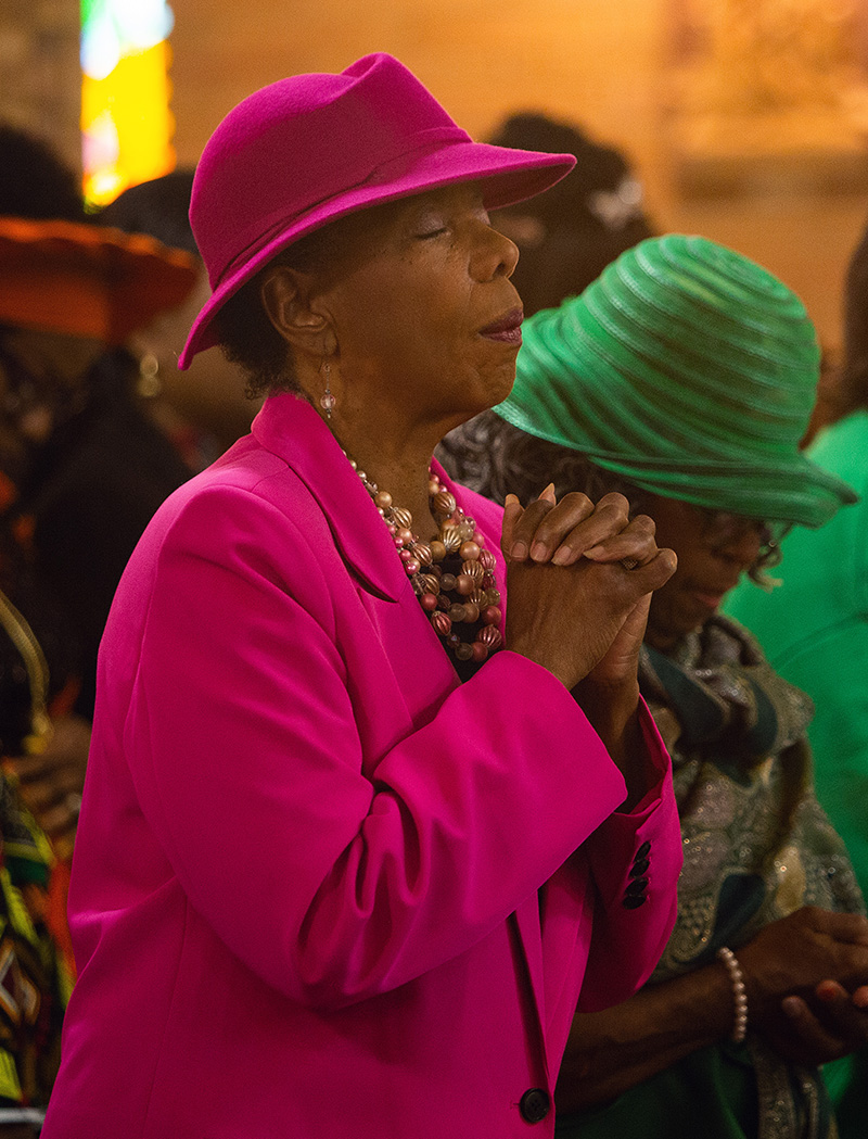 DECEMBER 14, 2025Marlene Quaroni/FCBernadette Poitier, religious education director, prays during MassArchbishop Thomas Wenski celebrated a 75th anniversary Mass at Holy Redeemer Church and installed Father Emmanuel John Essiet as pastor